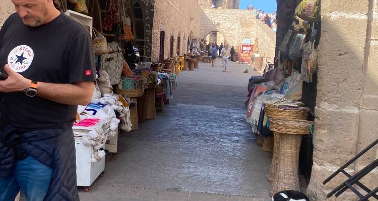 Market area with stalls and local shopping visitors.