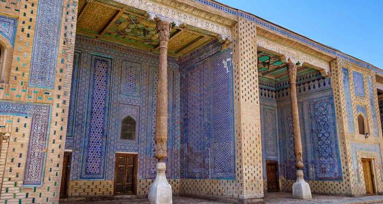 Colorful blue tiles and ornate columns at a historic building in Central Asia.