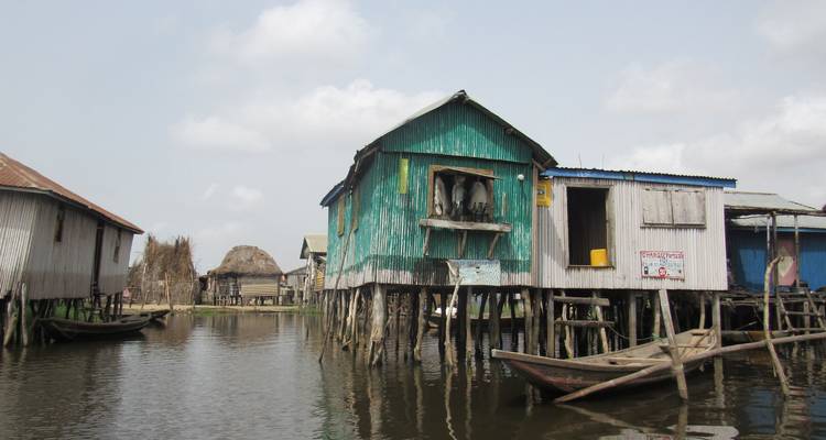 Stilt houses on water in a village setting