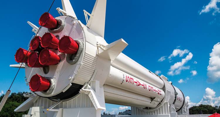 Space rocket on display with a clear blue sky.