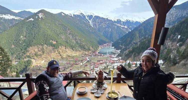 Couple dining with picturesque mountain and valley view.