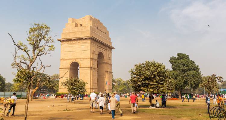 Porte de l'Inde avec des visiteurs autour dans un cadre de parc.