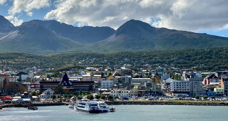 Coastal town with mountains in the background.
