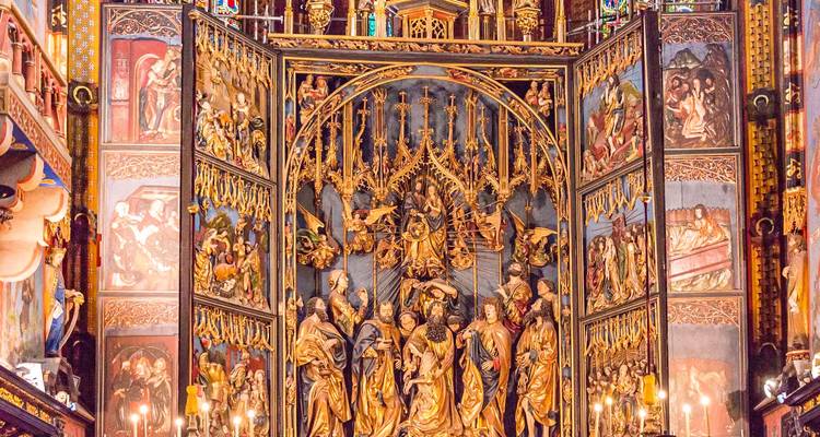 Richly gilded and painted altar triptych inside St. Mary’s Basilica in Krakow, filled with detailed biblical scenes.