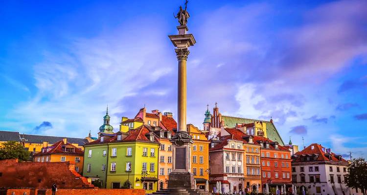 Colorful historic townhouses and Sigismund's Column rising above the main square under a vivid blue sky.