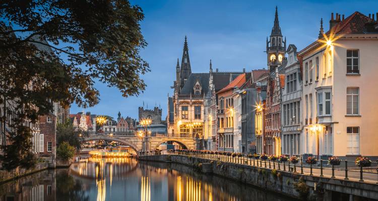 Beautiful canal cityscape at dusk with historic buildings.