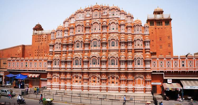 The iconic pink sandstone facade of Hawa Mahal with street activity.