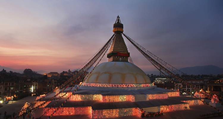 Erleuchtete Stupa, die am Abend mit Lichtern geschmückt ist.