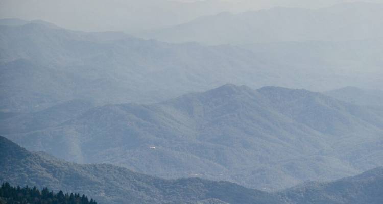 Hazy mountain landscape with multiple ridges.