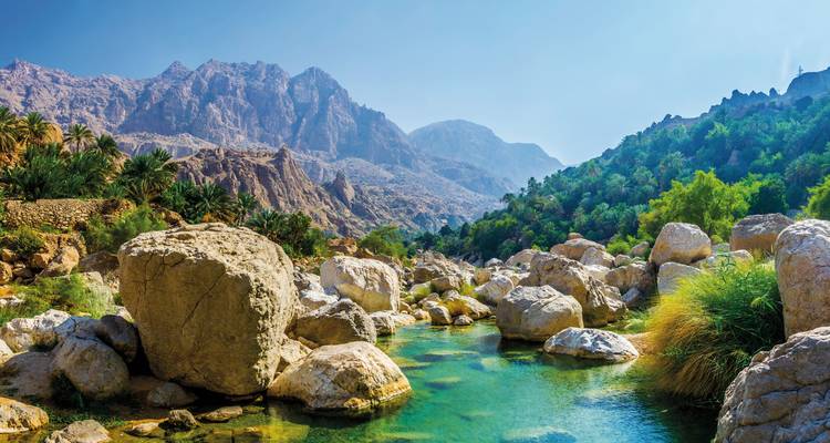 Stream surrounded by rocky mountains.