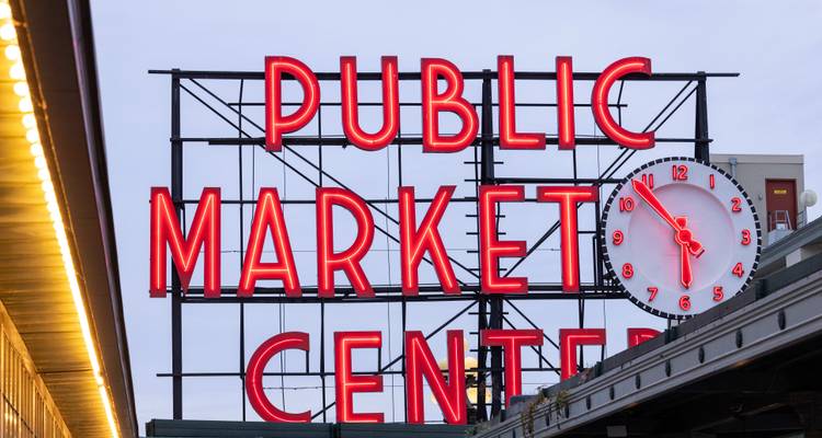 Iconic red neon sign of Pike Place Market in Seattle.