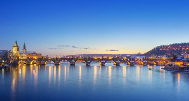 Panoramic view of Charles Bridge at dusk in Prague.