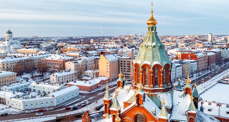 Aerial view of Helsinki with the Uspenski Cathedral and snowy rooftops.