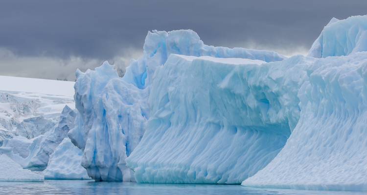Formaciones de hielo masivas en el mar contra un cielo nublado.