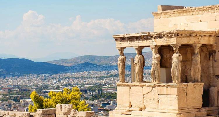 The elegant Caryatid Porch of the Erechtheion overlooks Athens and distant mountains.