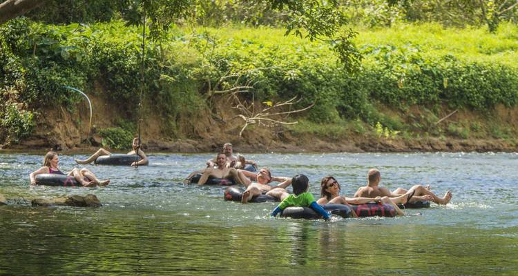 Translation from English to French:

"Descente de groupe en bouée sur une rivière tranquille."

Alternative translations:
- "Tubing en groupe sur une rivière paisible."
- "Descente collective en chambre à air sur une rivière calme."

Note: "Tubing" is sometimes kept as an anglicism in French, but "descente en bouée" or "descente en chambre à air" are more proper French translations.