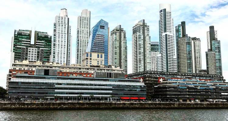 Skyline moderner Gebäude mit einem Gewässer davor.