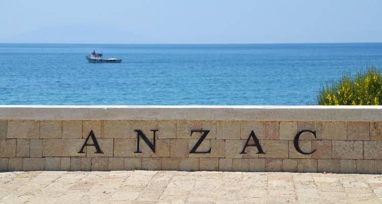 ANZAC memorial by the sea with a distant boat.