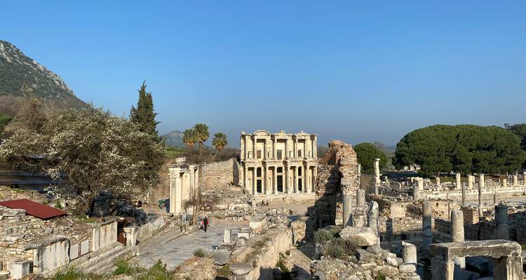 Ruins of an ancient city with stone structures and columns.