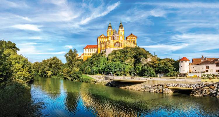 Melk Abbey with river and trees in the foreground.