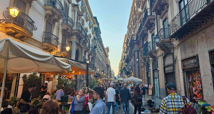 A bustling street with people and shops.