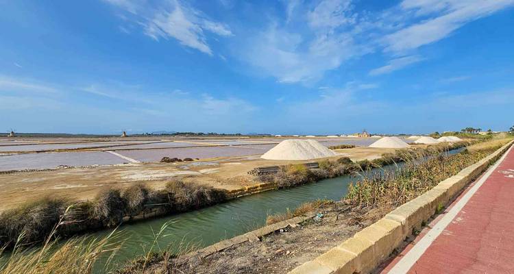 A series of salt evaporation ponds under a clear sky.