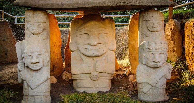 Historic stone statues under sunlight in an archaeological park.