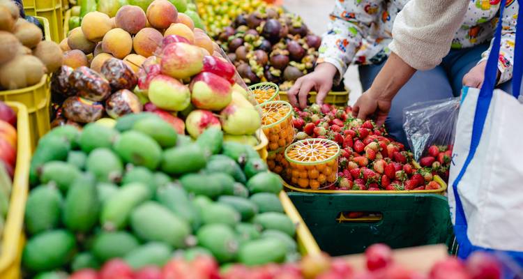 Assortment of fresh fruits displayed at an outdoor market.