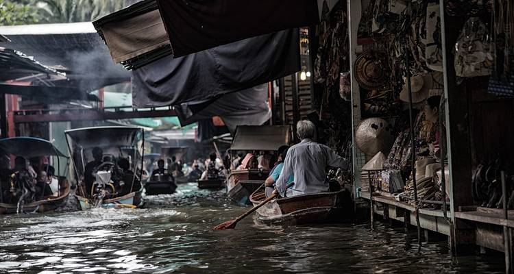 A busy floating market scene with boats and people.