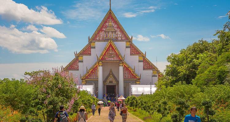 People visiting a large and colorful temple with ornate decorations.