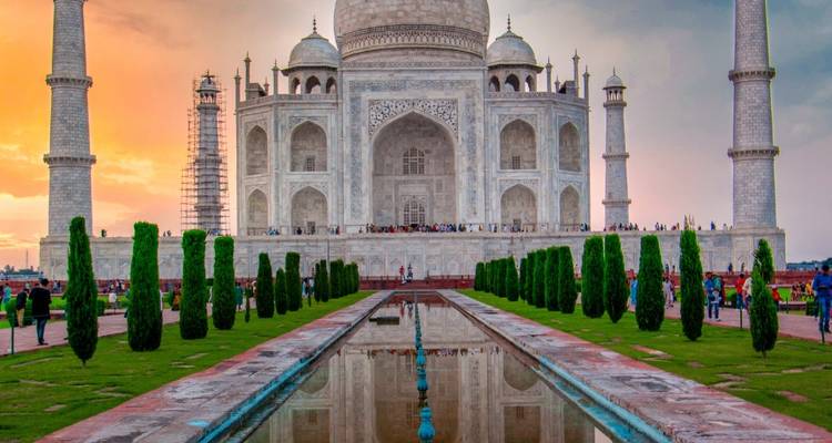 The iconic Taj Mahal at sunset with vibrant colors in the sky.