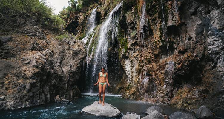 Person standing under a waterfall