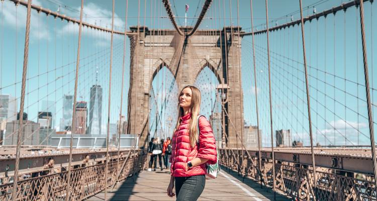 Person standing on a famous suspension bridge.