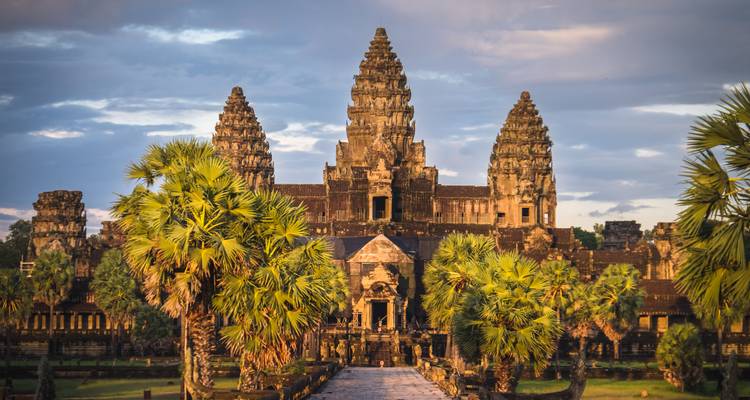 Ancient temple of Angkor Wat surrounded by lush greenery.