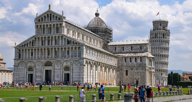 Crowds explore the Pisa Cathedral complex with the famous Leaning Tower rising beside it.