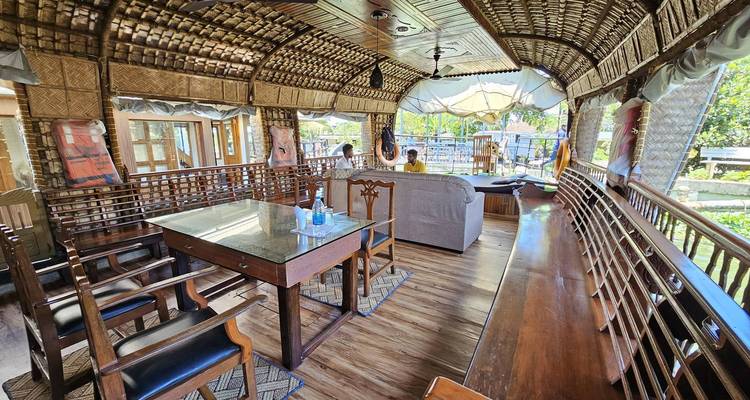 Interior of a houseboat with traditional decor and seating.