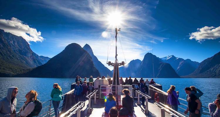 Passengers enjoying a cruise surrounded by fjords.