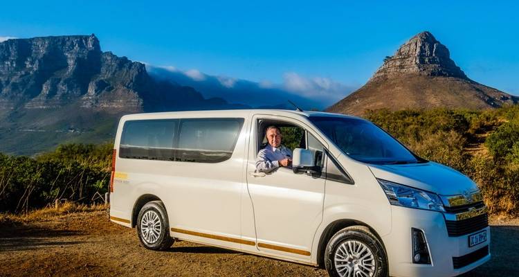 Person in einem Van vor dem Löwenkopf-Berg.