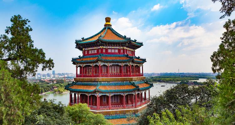 Colorful traditional Chinese pavilion overlooking a body of water.