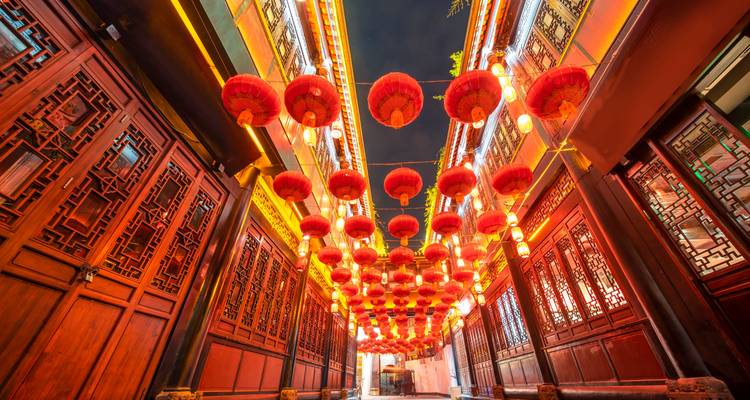 Lantern-filled alleyway at night.