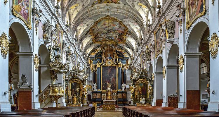 Prachtvolles Barockkirchen-Interieur mit vergoldeten Altären und freskenbemalten Deckenbögen.