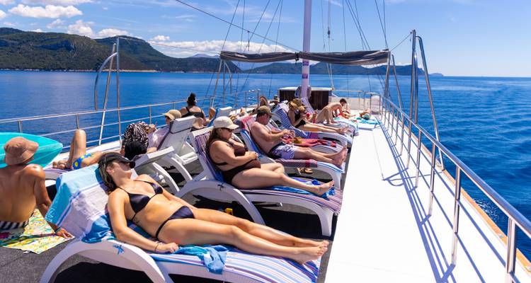 People relaxing on a yacht enjoying the sun.