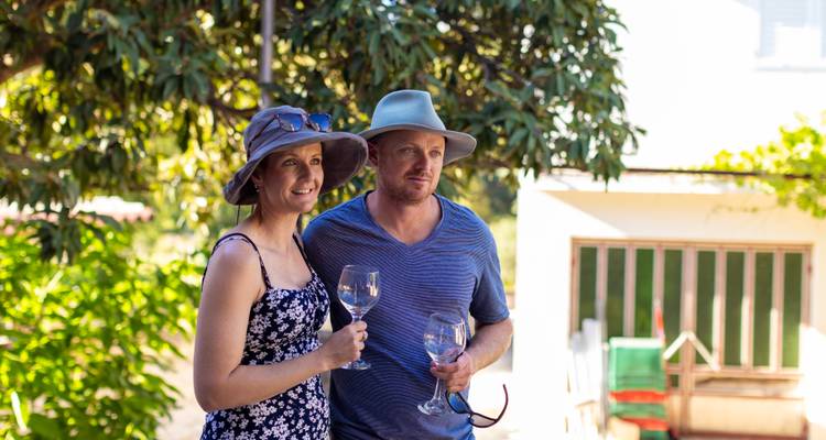 Couple enjoying a glass of wine outdoor.