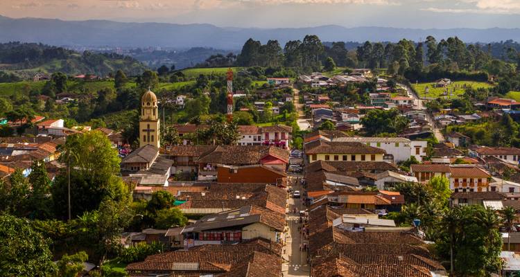 Town with a church tower and colorful rooftops.