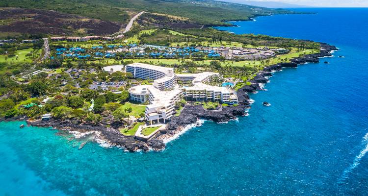Aerial view of a coastal resort with blue ocean water.