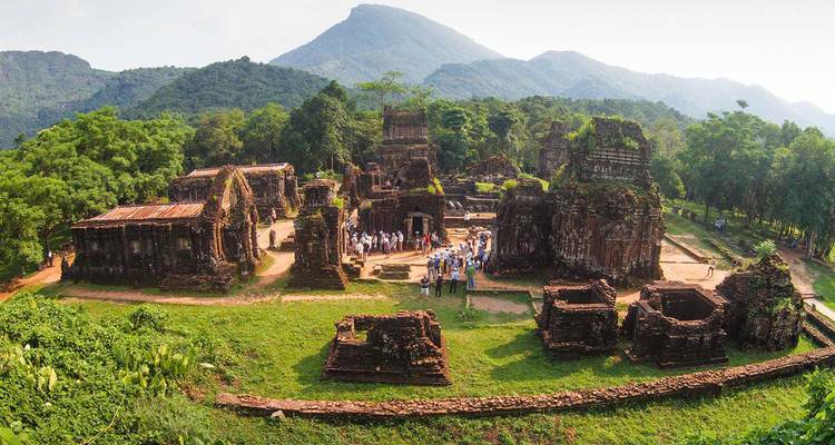 Aerial view of an ancient ruin complex with tourists.