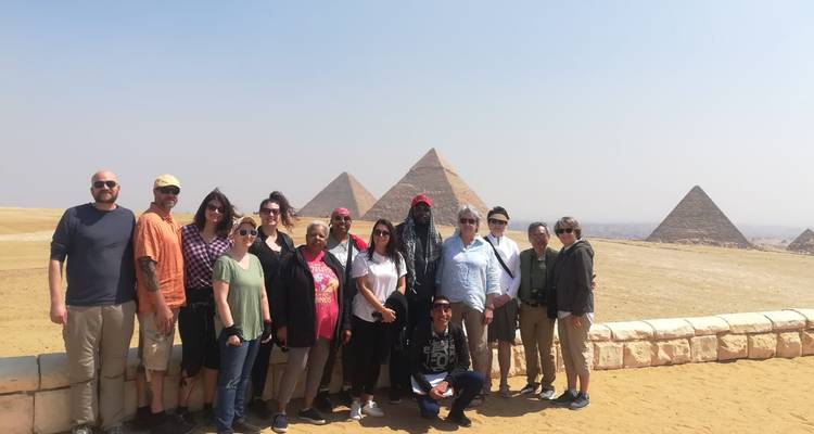 Tour group posing in front of the Pyramids
