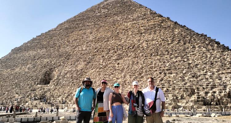 Tourists standing in front of the Great Pyramid at Giza.