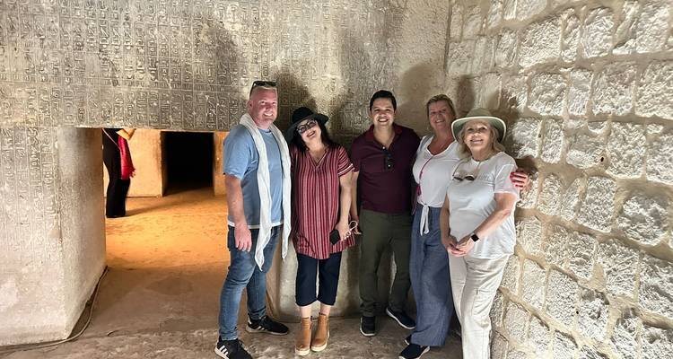 Group inside a historical crypt with hieroglyphic walls