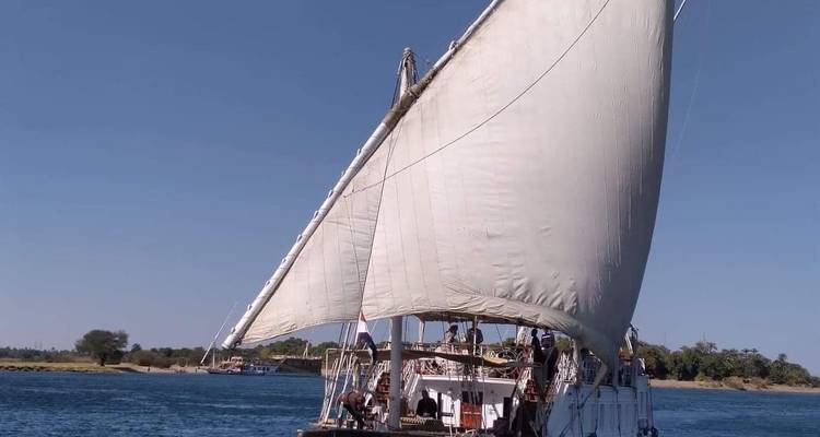 Sailboat with crew on a calm river